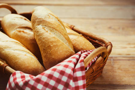 Fresh bread in  basket on a wooden table