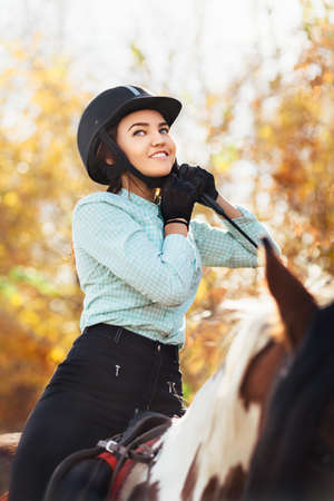 Horsewoman. Outdoor portrait of young beautiful woman. Selective focus