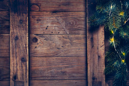 Christmas decoration with festive garland on a wooden surface. Christmas background with copyspaceの写真素材