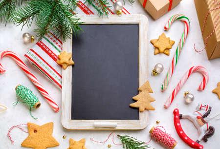 Slate board with Christmas decoration on a light background. Top view, horizontal.の写真素材