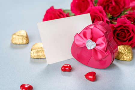 Roses bouquet, gift and blank greeting card for copy space. Valentines Day background