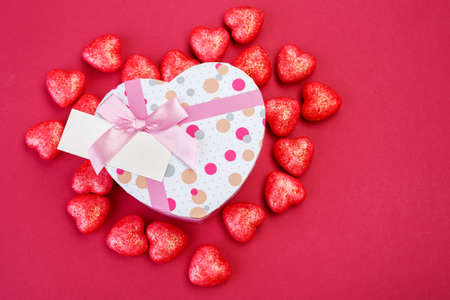Valentine's Day background. Gift box in the shape of heart and a lot of little hearts