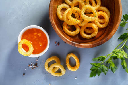 Fried onion rings  in batter with sauce. Food background, Top viewの写真素材