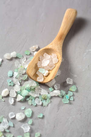 Sea salt on wooden spoon closeup. Shallow DOFの写真素材