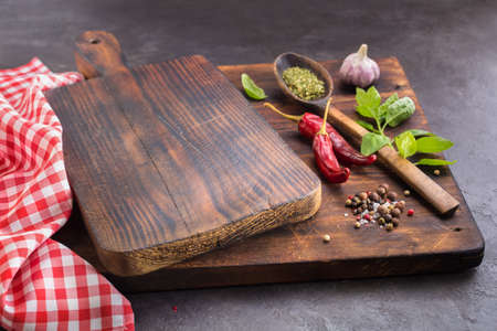 Cutting board and Spices.  Hot peppers, Basil, Garlic  and dried herbs. May be used as background