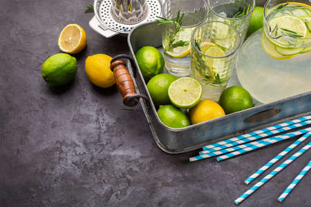 Homemade lemonade with fresh lemon, lime and rosemary, summer drink.  Food background with copyspaceの写真素材
