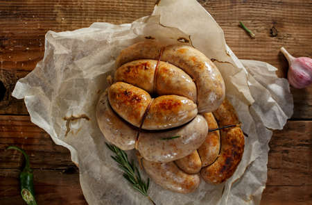 Homemade sausages and spices on wooden surfaceの写真素材