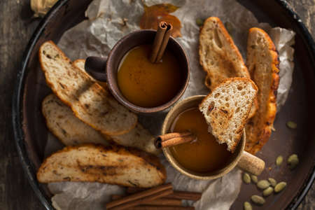 Spicy soup with croutons decorated with cinnamon sticks