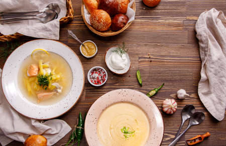 Assorted soups on the table, overhead view. Ukrainian and Russian National fish soup. Mushroom soup. Food background with copy space.の写真素材