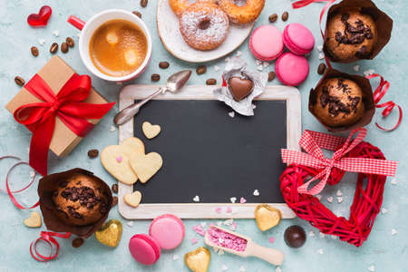Valentines Day. Gift box of kraft paper with a red ribbon coffee and variety of sweets.の写真素材