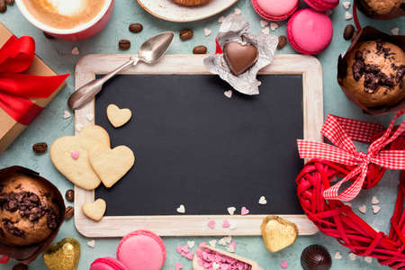 Valentines Day background with copyspace. Vintage blackboard and sweets. Toned.の写真素材