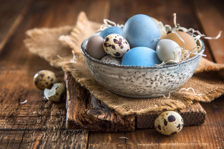Colored Easter eggs in a bowlの写真素材