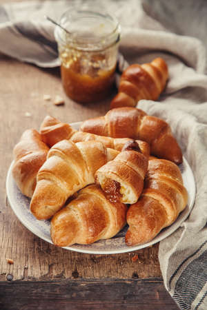 Fresh croissant with jam on old wooden table, Selective focus, rusticの写真素材