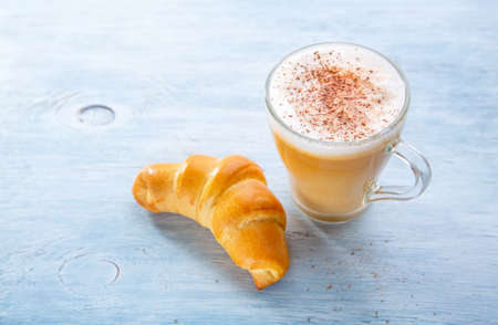 Breakfast with Latte macchiato coffee and croissant.の写真素材
