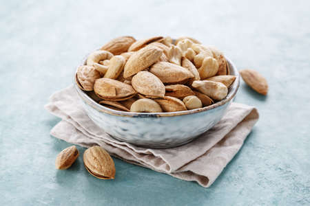 Almonds and cashews in a bowl closeup.の写真素材