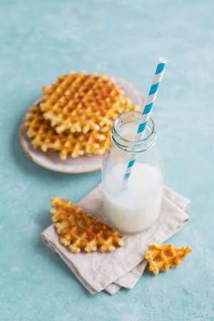 Homemade crispy waffles with milk. Food background, Selective focus.の写真素材