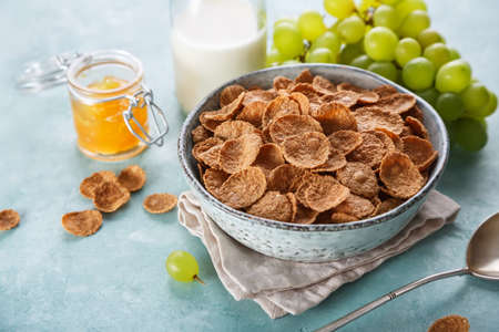 Wheat bran breakfast cereal with milk and jam. Healthy diet breakfast, selective focusの写真素材