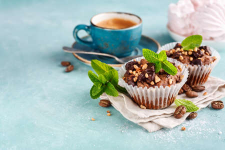 Chocolate Muffins garnished with Mint leaves and Coffee. Food background with copy space for your textの写真素材