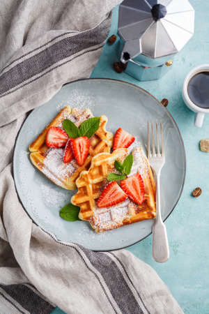 Homemade belgian waffles with strawberries and coffee. Delicious Breakfastの写真素材