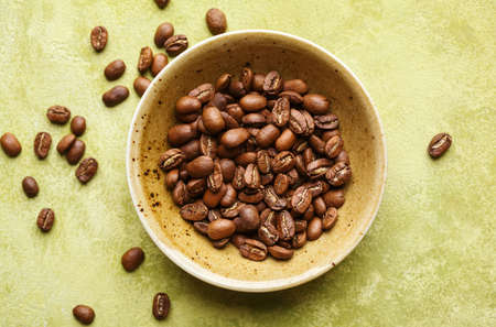 Fresh coffee beans in a bowl, top view. Selective focusの写真素材