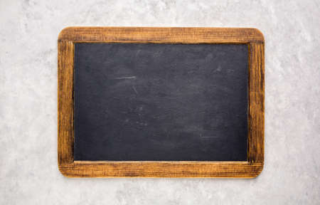 Small empty chalkboard on a light grey textured background. Blank. Blackboard Background. Blackboard textureの写真素材