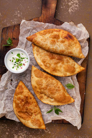 Traditional russian and caucasian pies - meat chebureks fried in oil.の写真素材