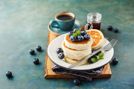 Cottage cheese pancakes with blueberries and coffee, Healthy Breakfast.の写真素材