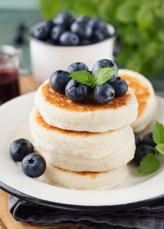 Cottage cheese pancakes with blueberries and mint, close up. Healthy Breakfast. Selective focusの写真素材