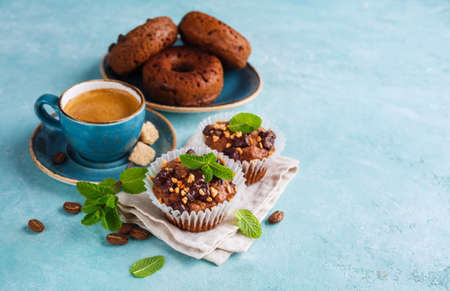 Chocolate Muffins with Mint, Coffee and Chocolate doughnuts. Food background with copy space for your text.の写真素材
