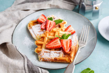 Homemade belgian waffles with strawberries and coffee. Delicious Breakfast.の写真素材