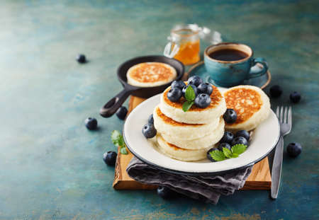 Cottage cheese pancakes with fresh blueberries and coffee, Delicious Breakfastの写真素材