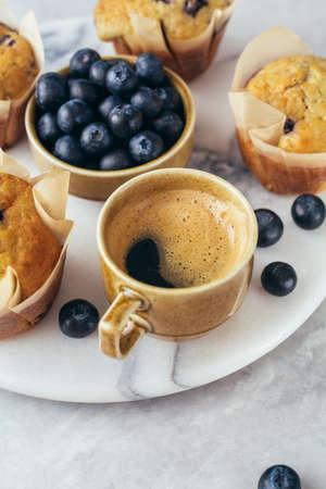 Cup of coffee and Homemade muffins with blueberries and coffee. Selective focus