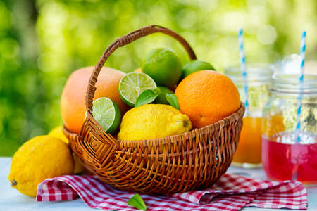 Mix of fresh citrus fruits in basket and juice. Health Food. Shallow DOFの写真素材