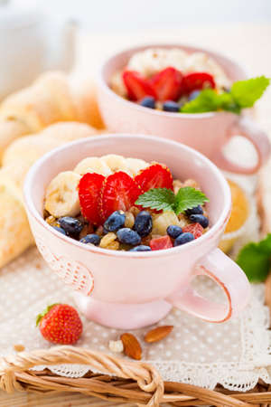 Porridge with banana and fresh berries in a cups. Healthy eatingの写真素材