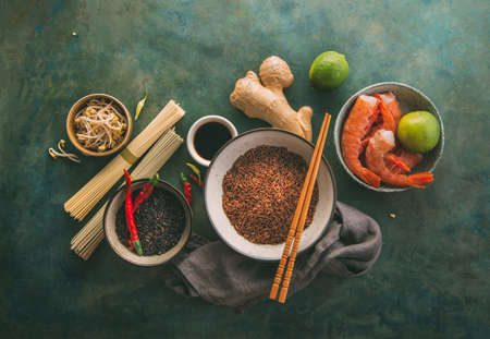 Different types of rice and dried asian noodles and spices.の写真素材