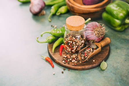 Pepper spice mix and hot pepper in pods, ingredients for cooking. Food background with copy space. Toned image.の写真素材