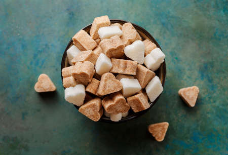 Brown cane sugar and a white sugar in a bowl. Top view.の写真素材