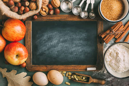 Empty chalkboard and ingredients for bakingの写真素材