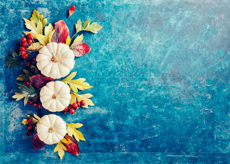 Holiday Background with small decorative pumpkins and autumn leaves.の写真素材