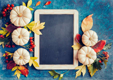 Autumn background with festive decoration and vintage chalkboard for your message.の写真素材