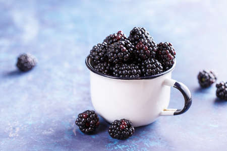 Juicy fresh blackberries in a cup. Organic healthy berries. Selective focusの写真素材