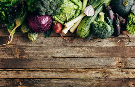 Fresh organic raw vegetables on a wooden table,top view. Healthy food background wiht copyspace.の写真素材