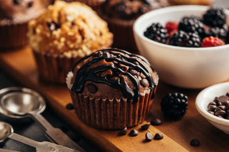 Muffins with chocolate and berries, close-up. Food backgroundの写真素材