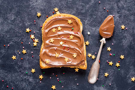 Toast with Chocolate with golden sprinkles on a dark background, Closeupの写真素材