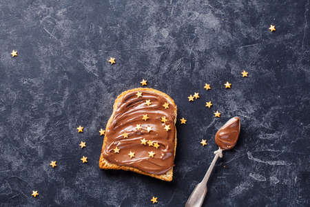 Toast with Chocolate with golden sprinkles. Food background wiht copy space.の写真素材