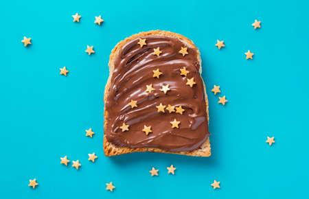 Toast with Chocolate with golden sprinkles on a blue backgroundの写真素材