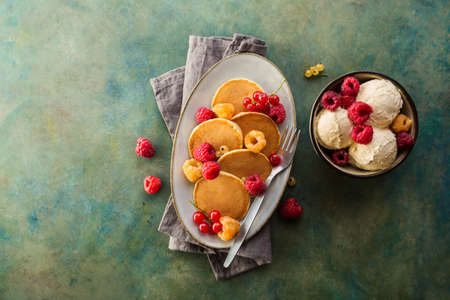 Homemade pancakes with fresh raspberries and mint, overhead shot. Copy spaceの写真素材