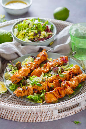 Chicken kebab with a lime and mint on a wicker tray. Healthy food.の写真素材