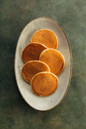 Freshly baked pancakes on the plate, top viewの写真素材