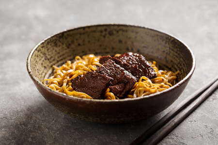 Asian noodle dish with beef in a bowl